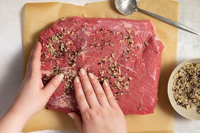 rubbing the brisket with spice mixture