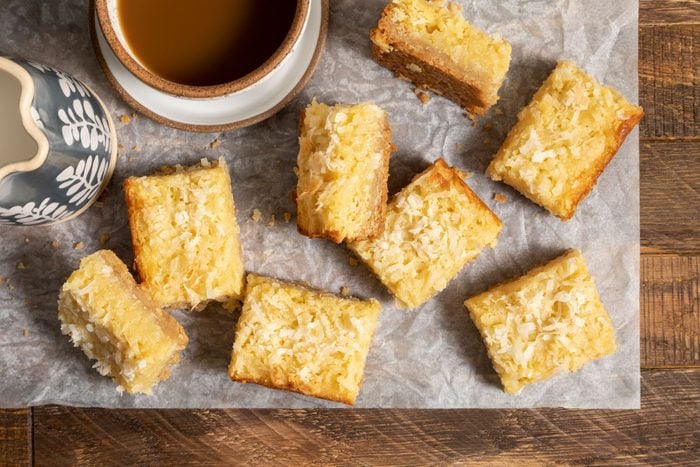 Buttery Coconut Bars on a wooden surface