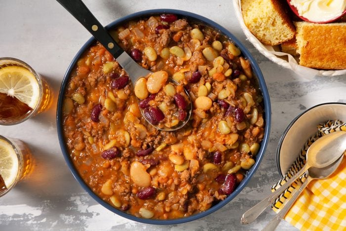 Calico Cowboy Beans served in a big bowl with beverages on the side