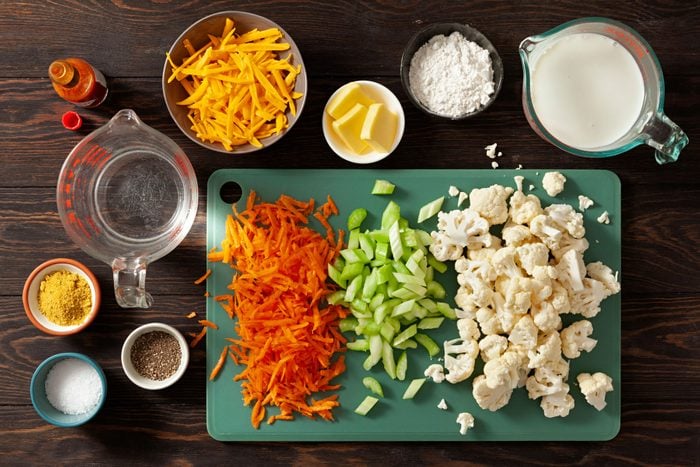 Vegetables cheese chicken and other ingredients on a table