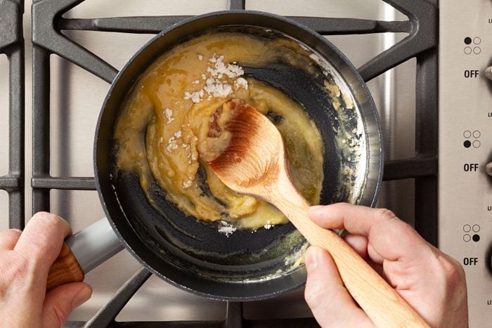 Cooking the flour and butter mixture in a large saucepan
