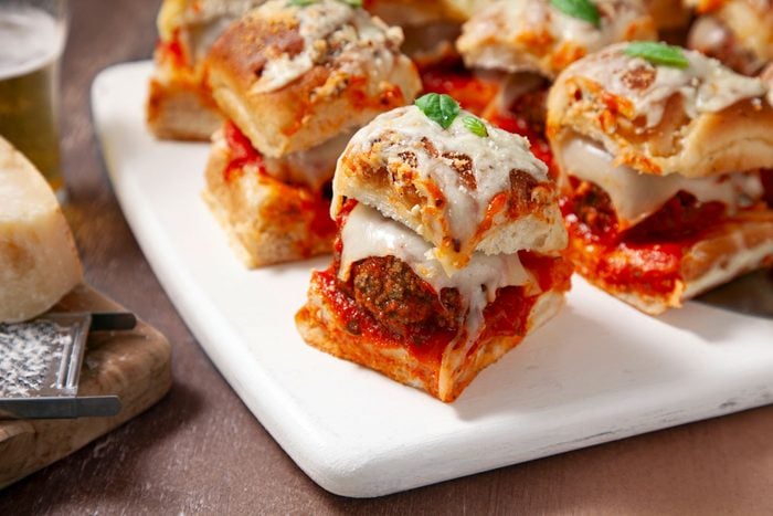 Cheesy Meatball Sliders served on plates on a wooden table