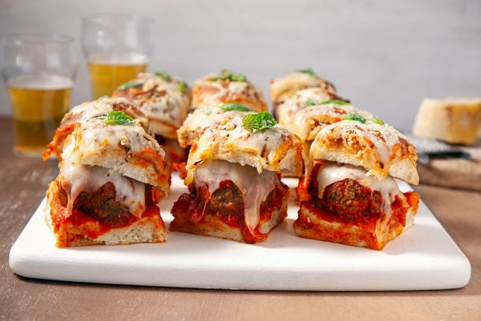 Cheesy Meatball Sliders in a white plate on a wooden table