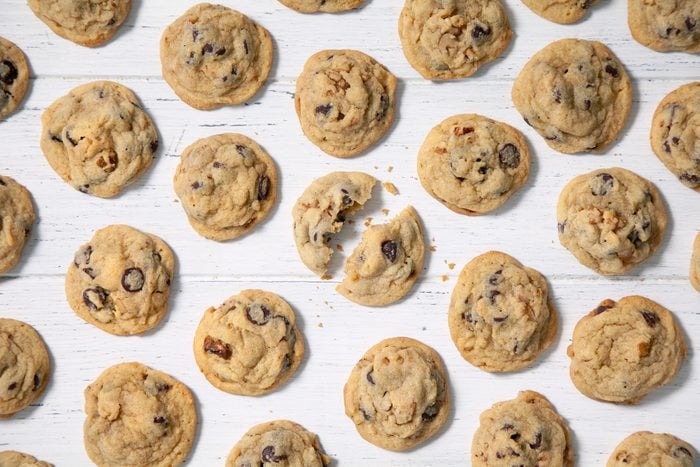 Chewy Chocolate Chip Cookies laid down on white wooden background