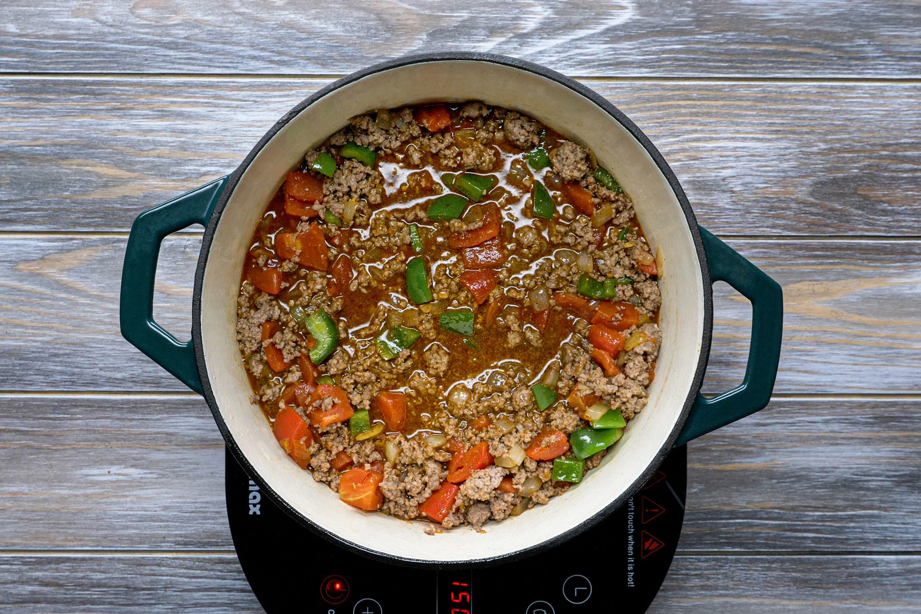 Ground beef and vegetables cooking in a Dutch oven