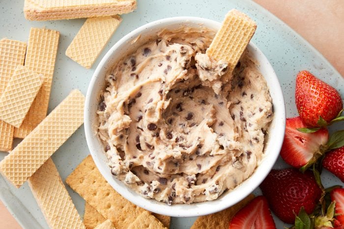 A bowl of chocolate chip dip with a cracker on top