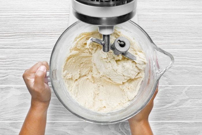 creamed mixture in a large bowl being mixed with hand mixer