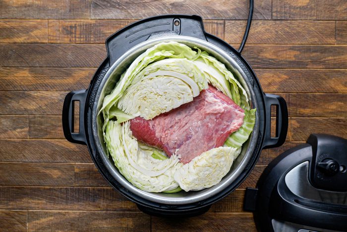 Brisket and cabbage placed in the slow cooker