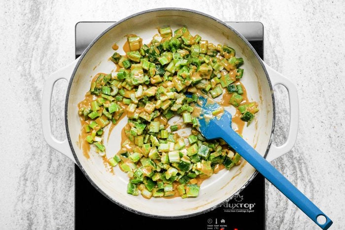 Stir celery, pepper and onions in a skillet