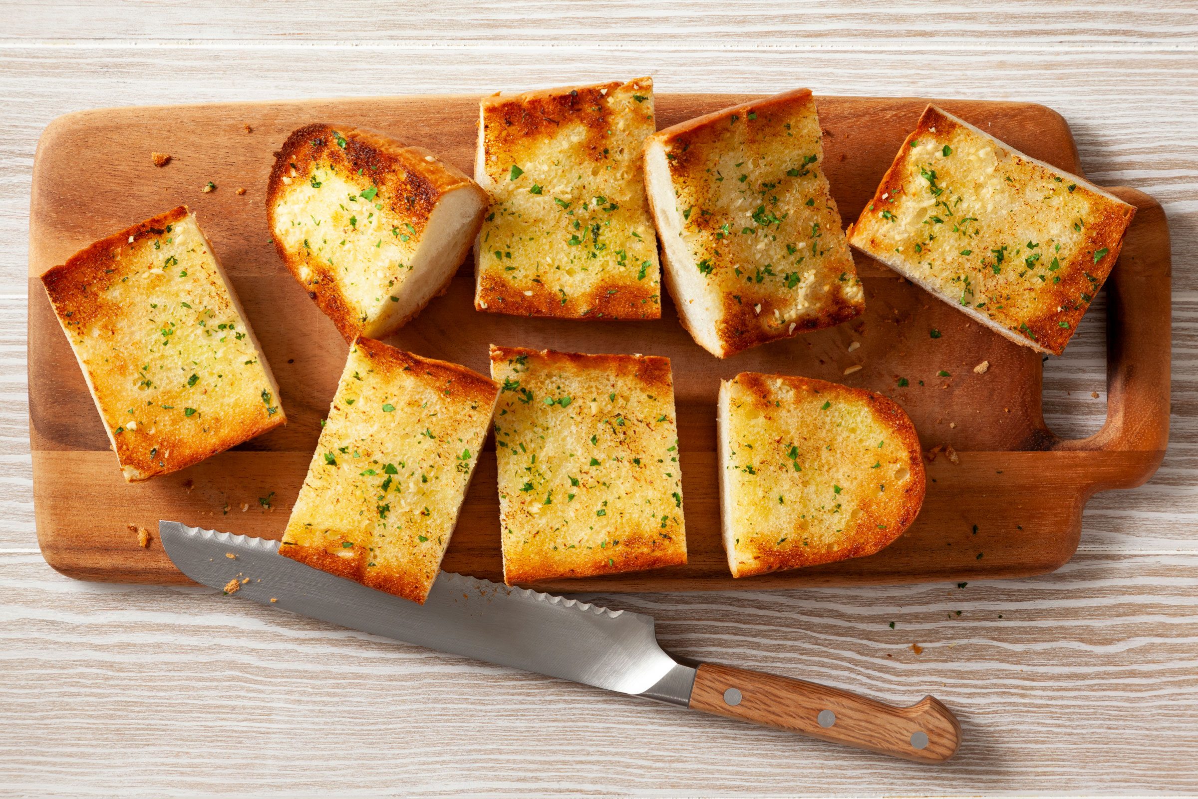garlic bread on a wooden cutting board and cut into slices