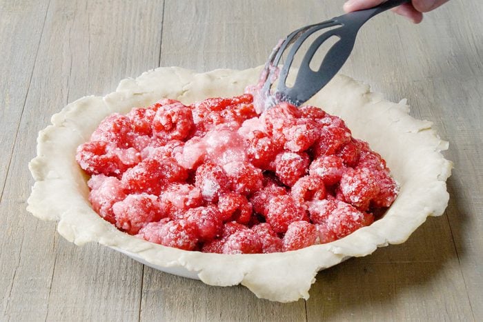 filling raspberry into the dough 