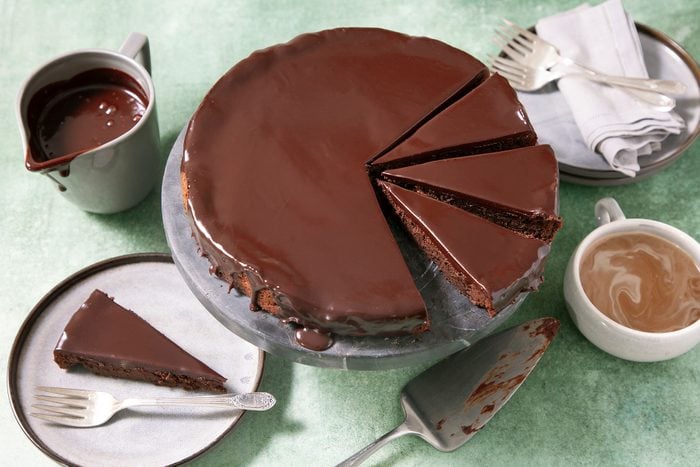 Sliced Flourless Chocolate Cake on cake stand 