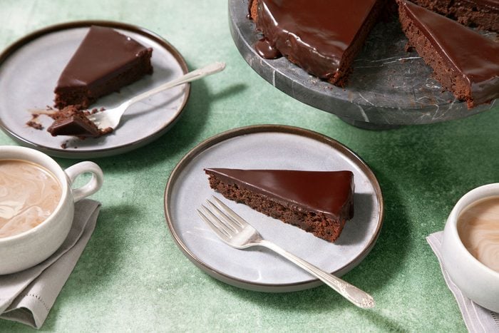 Slices of Flourless Chocolate Cake served on plates with fork