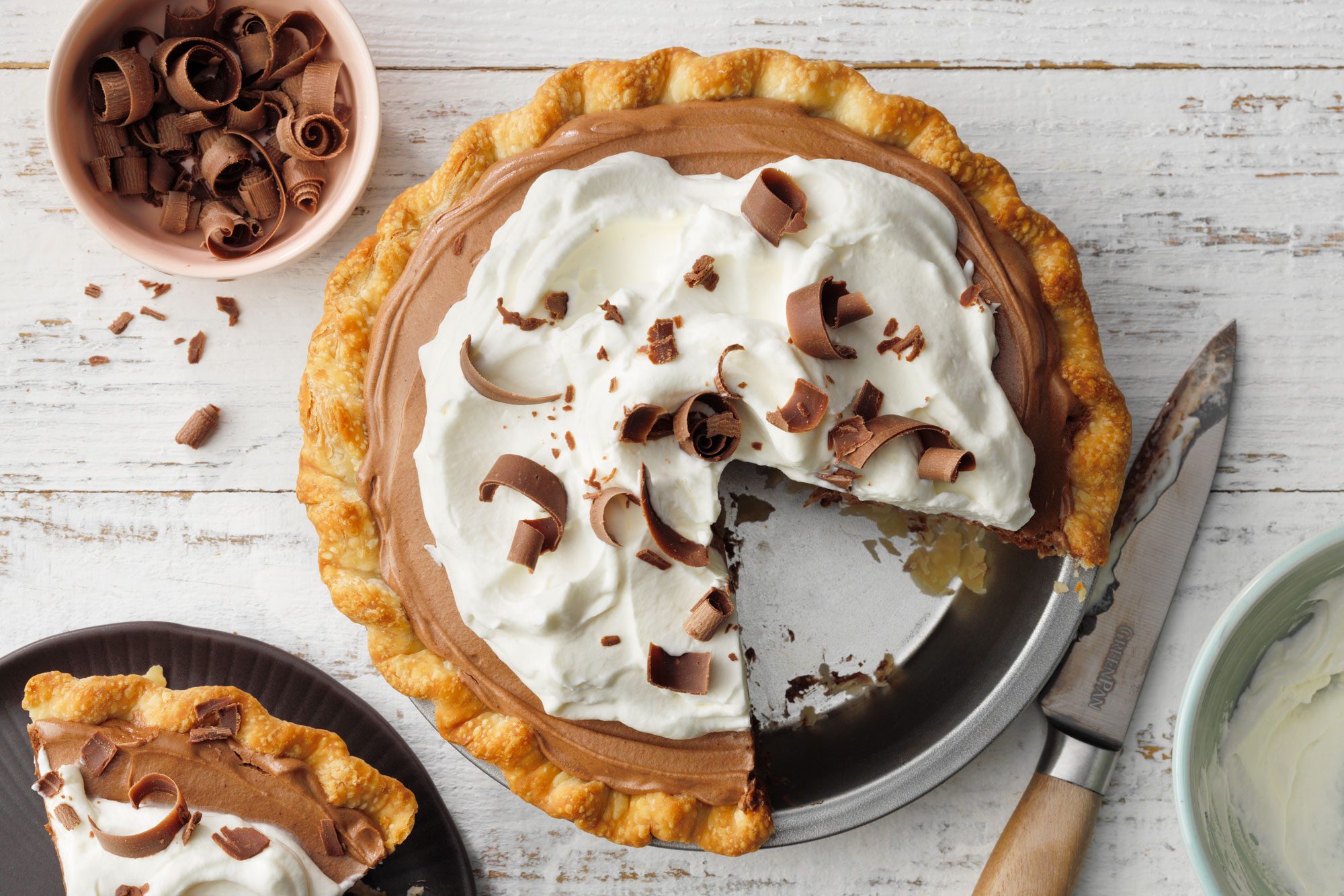 French Silk Pie in a steel pie plate on white painted wooden surface