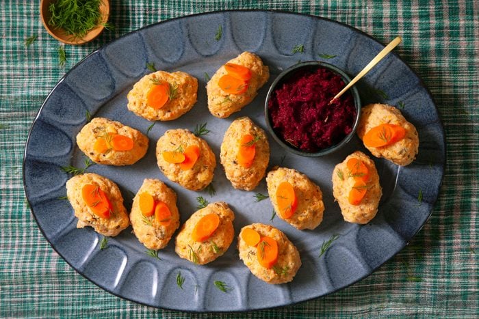 Gefilte Fish served in a large plate with carrots on top