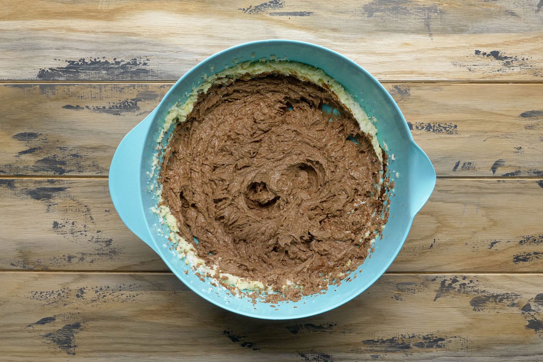 Melted chocolate mixed in a large bowl to make a cake