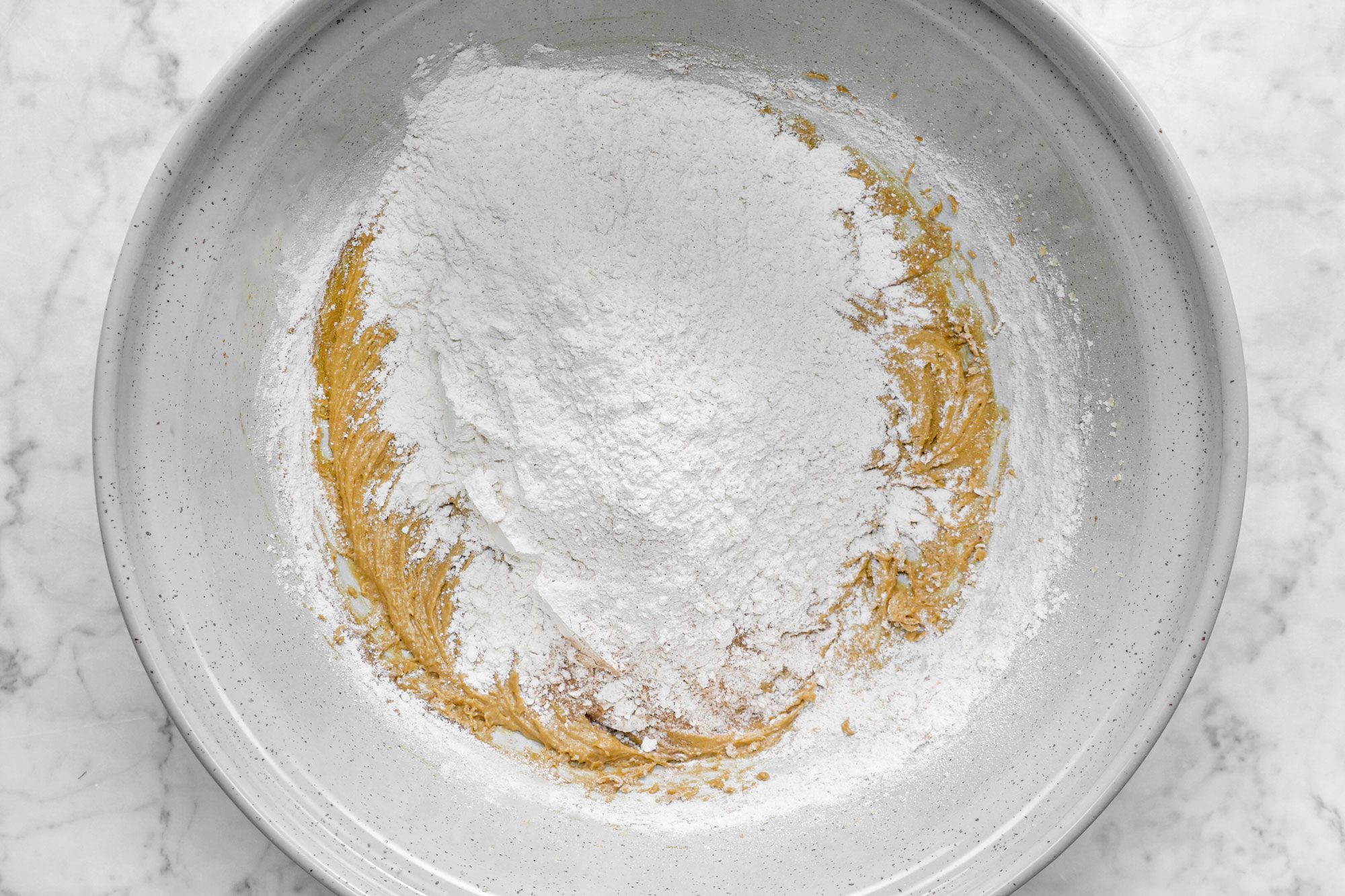 Flour in A Large Mixing Bowl on Marble Surface