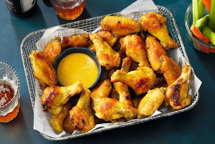 Honey Mustard Chicken Wings served in a basket with drinks