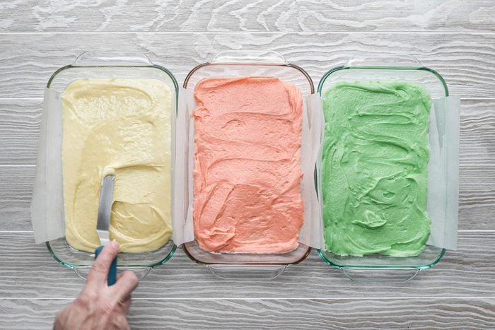 Spreading different color batter in 3 different baking dish