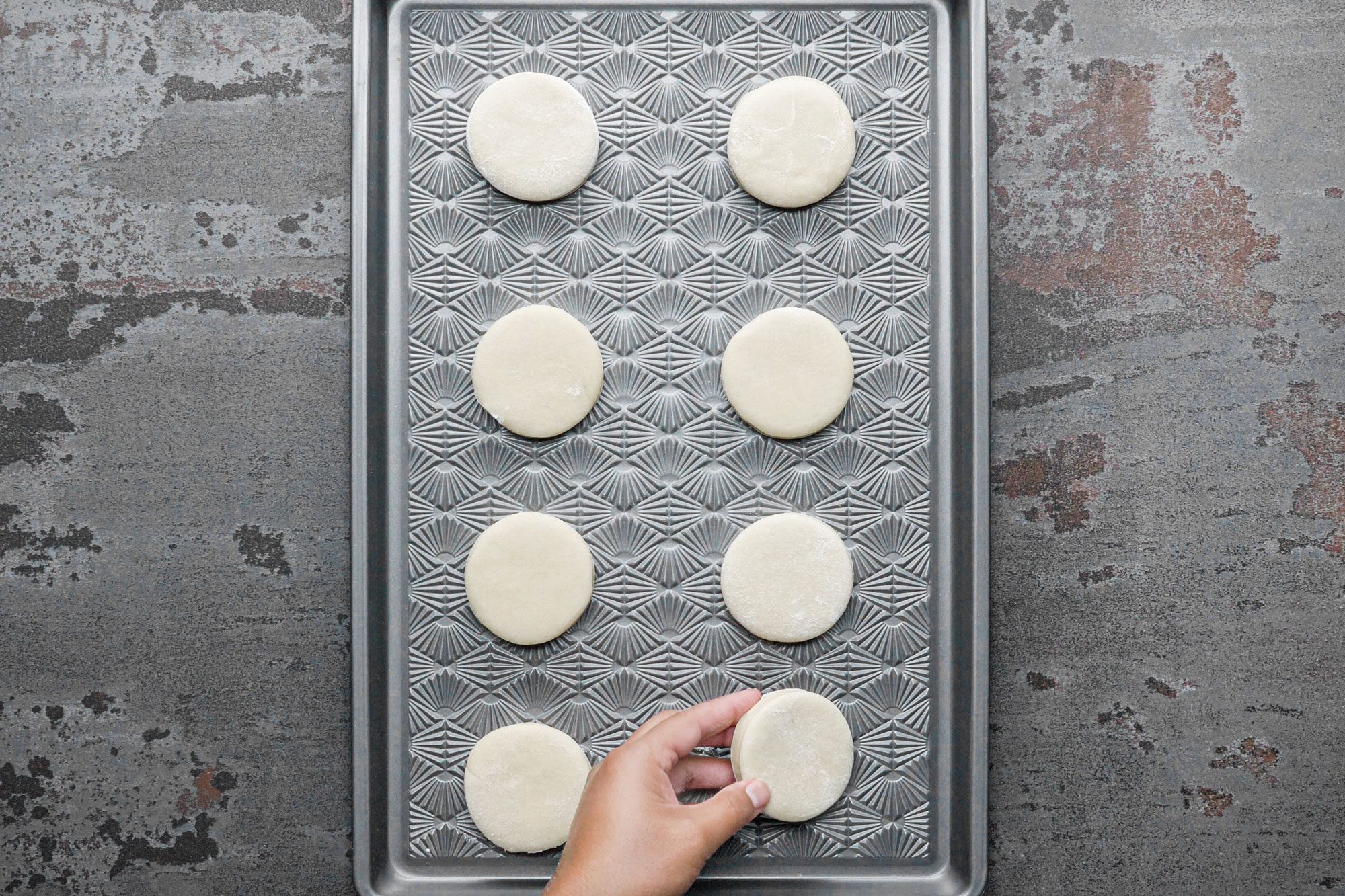 small round shaped dough pieces placed on a baking tray