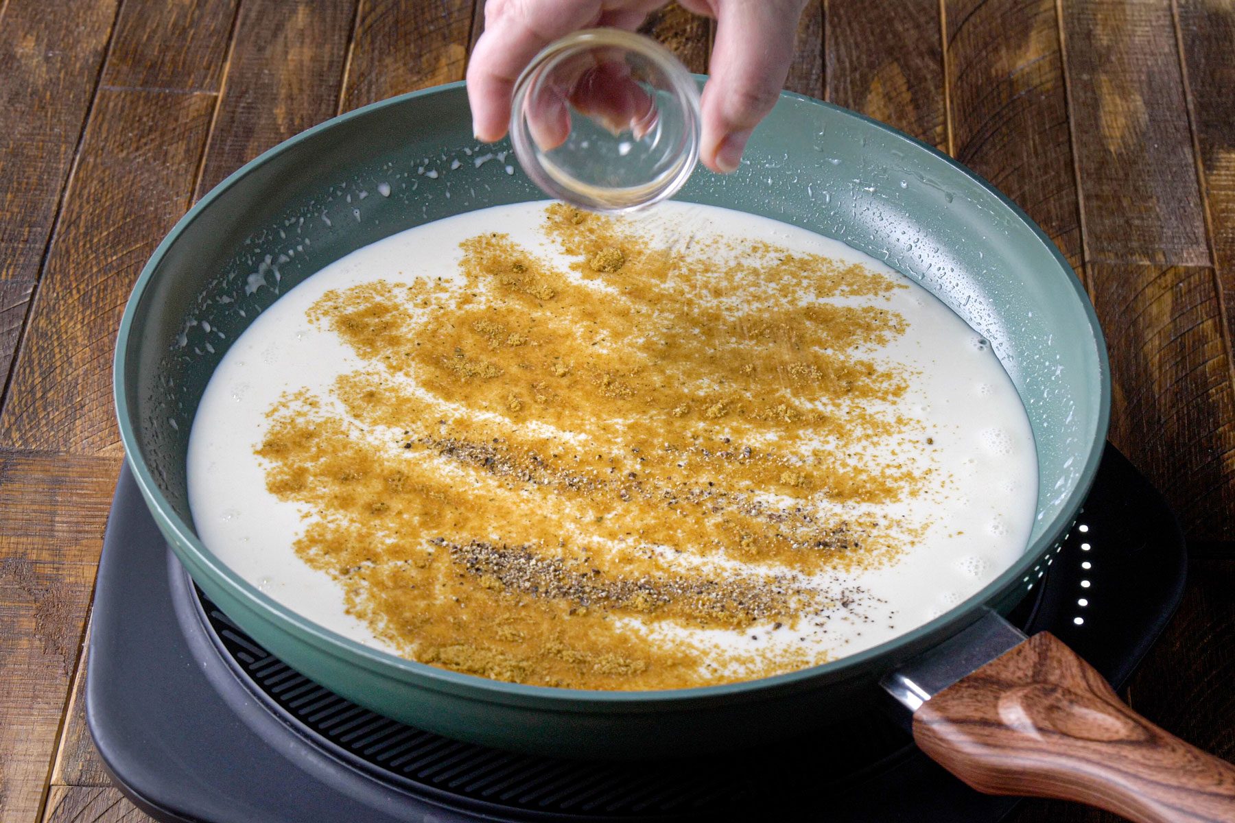 Pepper and milk is cooked in a sauce pan 