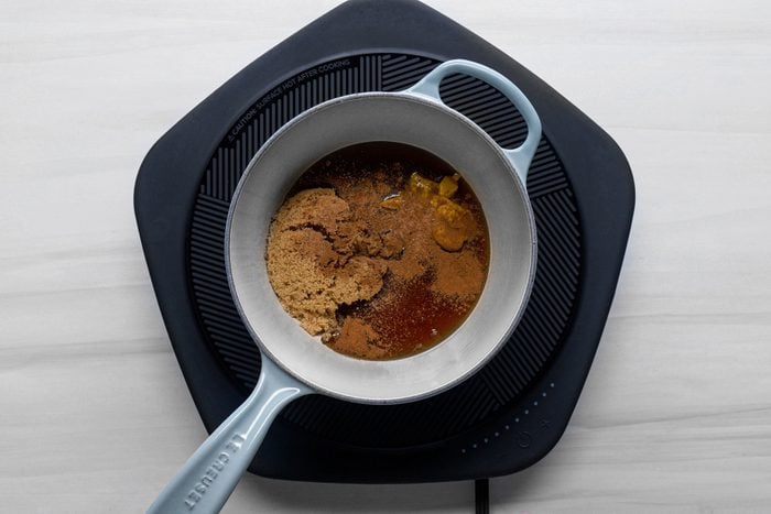 Cooking brown sugar, maple syrup, prepared mustard in a large sauce pan