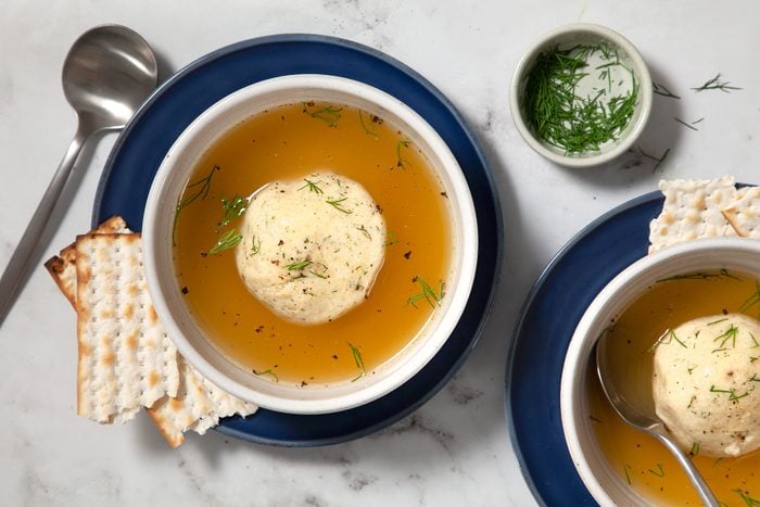 Two bowls of chicken soup with matzo balls