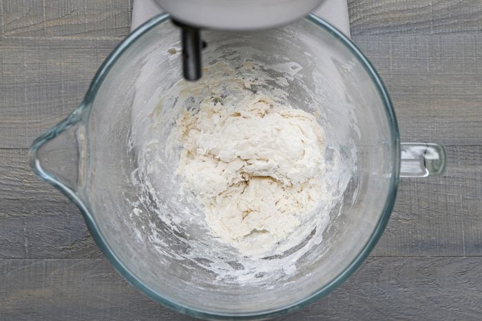 Combine the oil, salt, proofed yeast and a cup of flour in a bowl with stand mixer