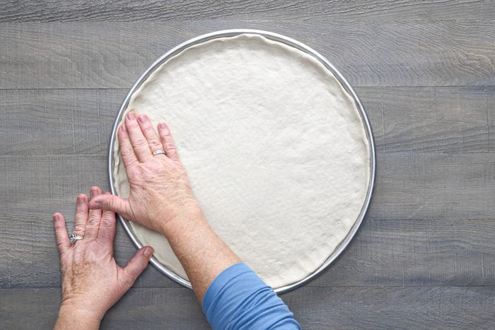 Roll out the dough in pan and form a narrow rim on the sides