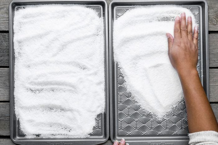 Spreading kosher salt in two big pans