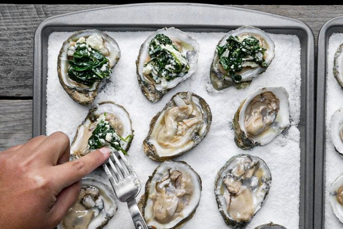 Dressing the oysters with sauce 