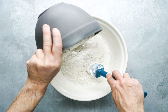 Adding flour to the bowl
