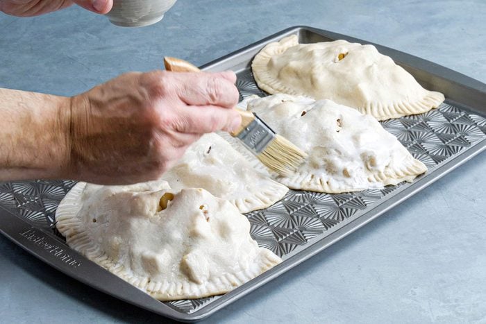 Placing the unbaked pasties on baking tray