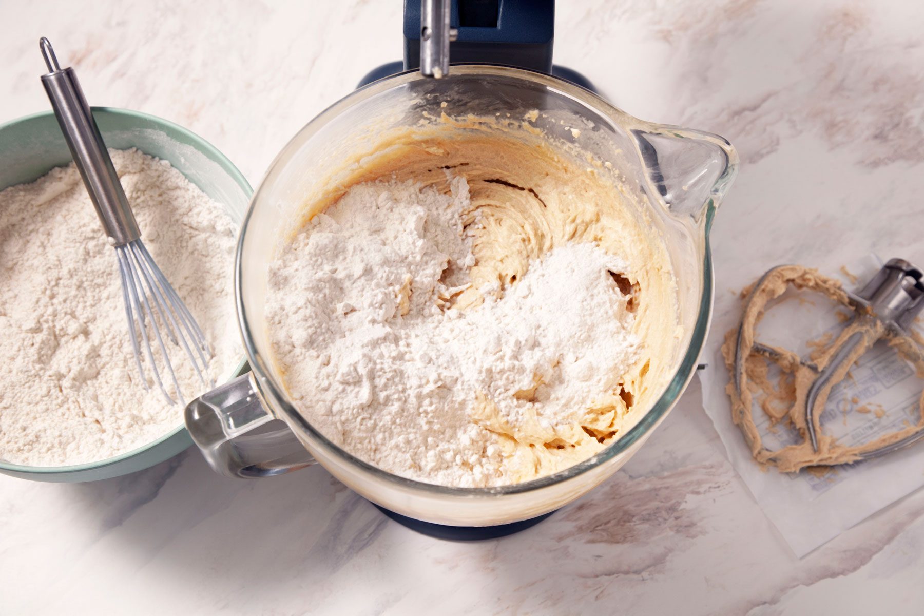 Mixing the flour into the creamed mixture in a blender