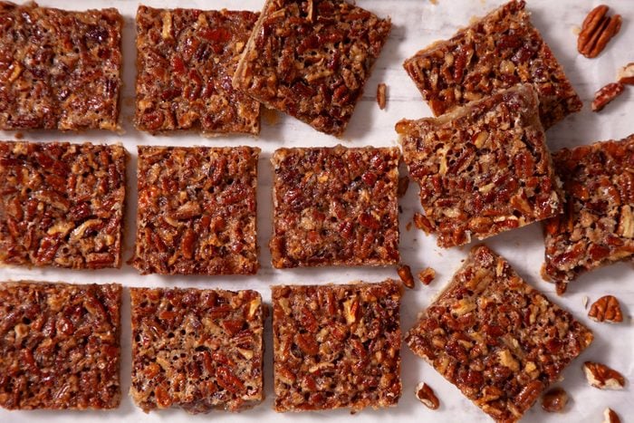 Pecan Pie Bars arranged on a plain surface ready to serve
