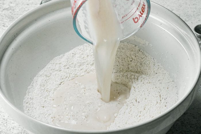 Adding yeast in flour in large bowl