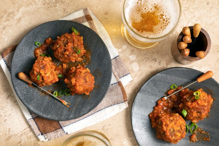 Porcupine Meatballs in sauce served in plates with beer on the side