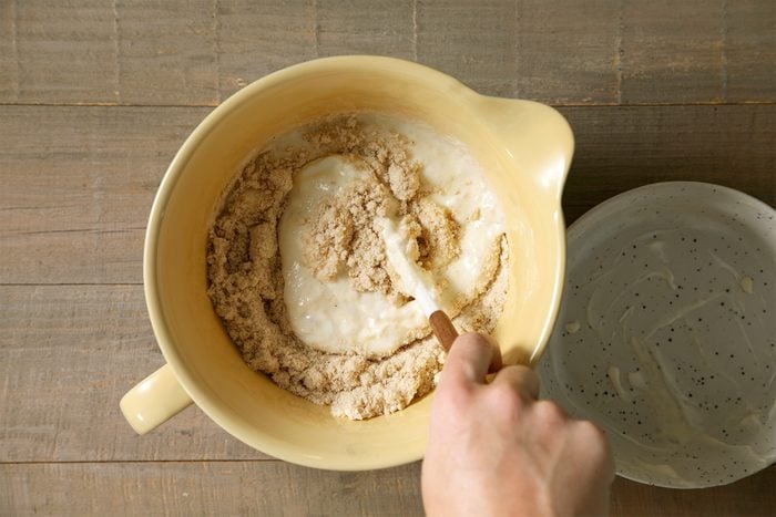 a Person making Pancake Batter in bowl