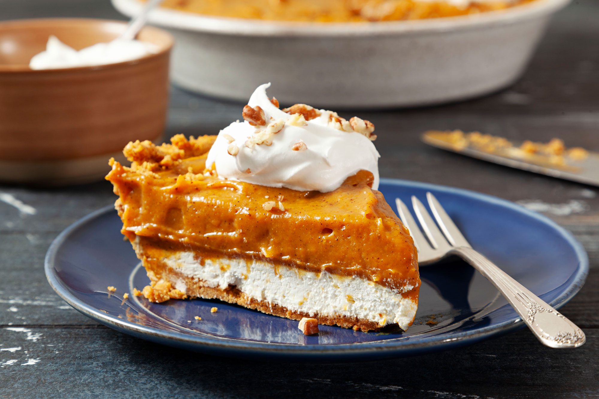 A slice of Pumpkin Chiffon Pie on a plate with a fork