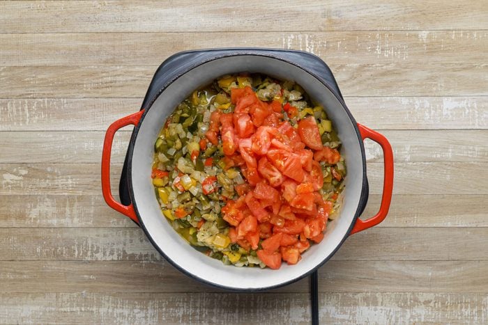 Stir the tomatoes with the vegetables in a large pan