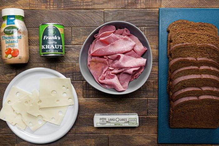 Corned beef bread cheese and other ingredients on a wooden table