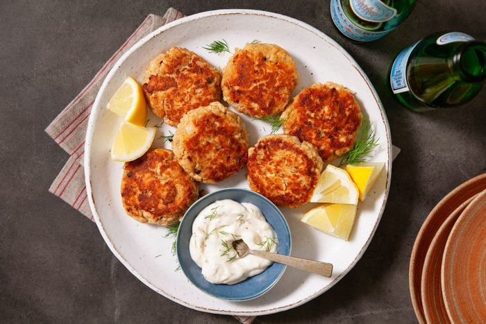 Salmon Patties with Lemon Wedges on a White Plate