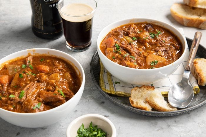 Slow Cooker Guinness Beef Stew served on plate with breads