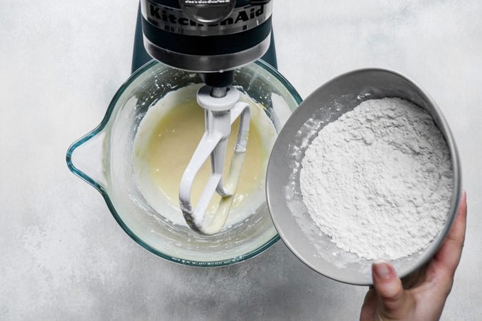 Mixing flour in the creamed mixture in a large bowl