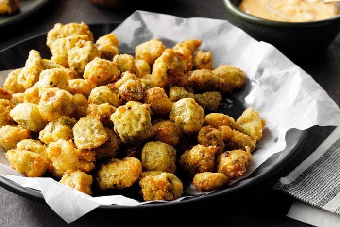 Crispy Southern fried okra with side dish on a table