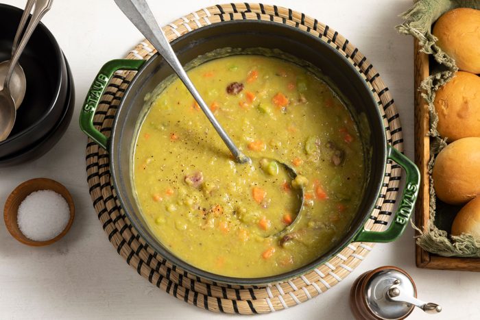 Split Pea Soup served in a large pan placed on a white surface