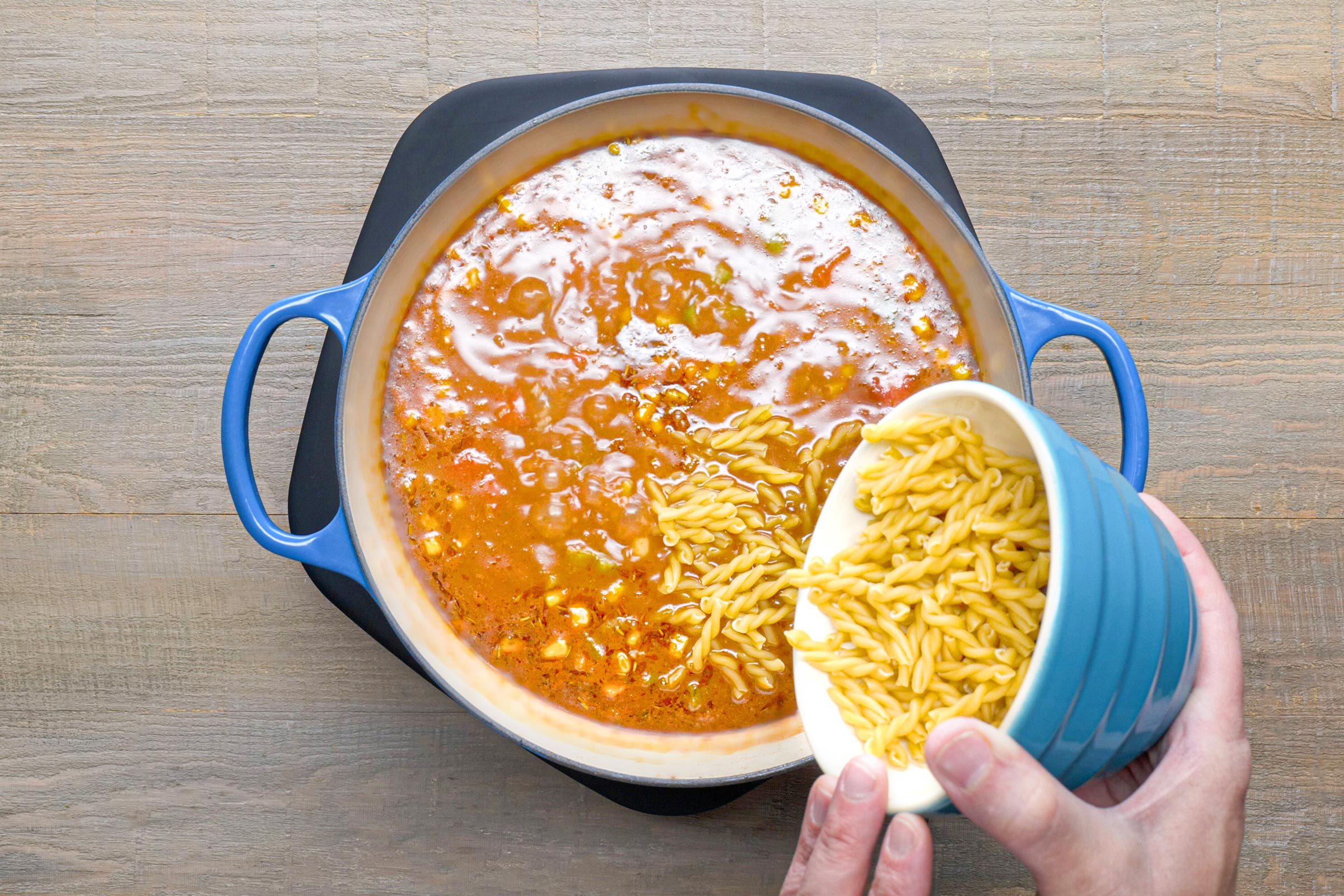 sprinkle cheese into large pot of lasagna soup