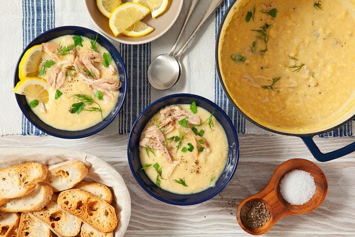 Avgolemono Soup served in bowls with bread on the side