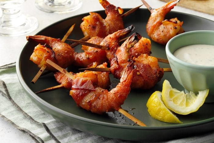 Bacon wrapped shrimp with with ranch dip and lemon wedges