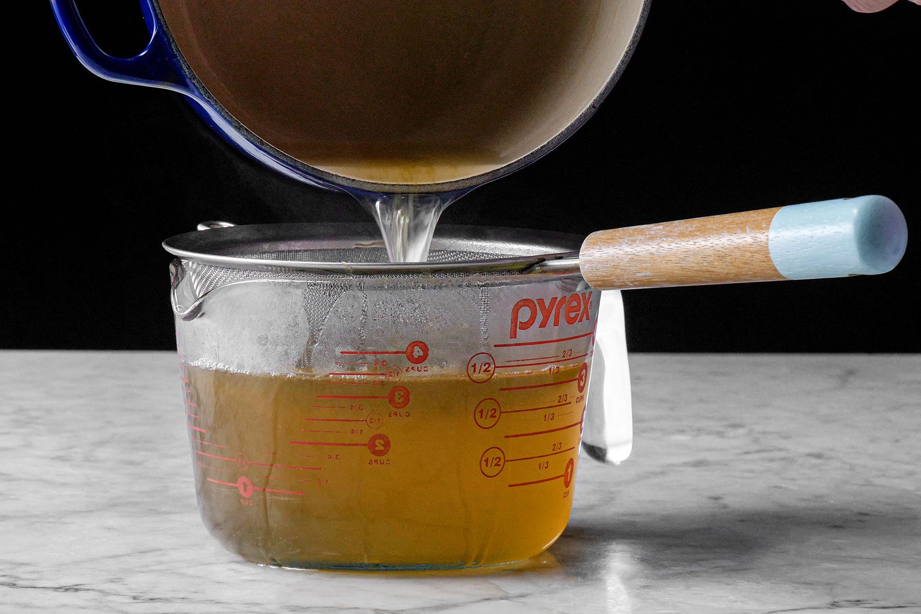 Straining the syrup into glass container